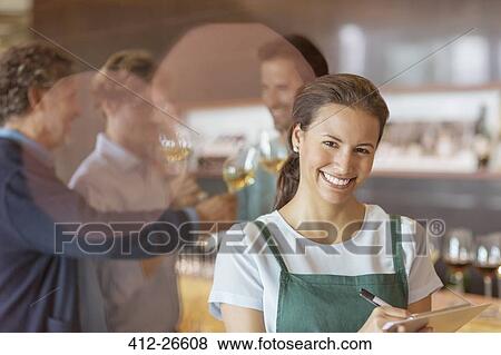 Portrait smiling worker with clipboard in winery tasting room View Large Photo Image Stock Photo - Portrait smiling worker with clipboard in winery tasting room. Fotosearch