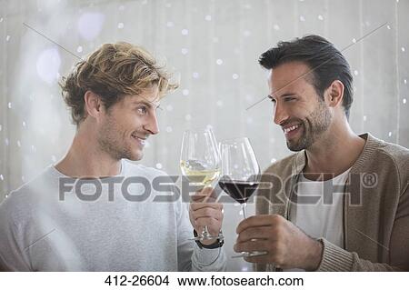 Smiling men toasting wine glasses View Large Photo Image Picture - Smiling men toasting wine glasses. Fotosearch