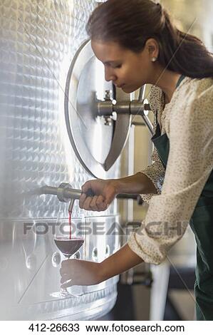 Vintner barrel tasting red wine in stainless steel vat View Large Photo Image Stock Image - Vintner barrel tasting red wine in stainless steel vat. Fotosearch