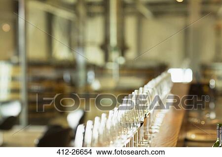 Wine glasses in a row on counter in winery tasting room View Large Photo Image Picture - Wine glasses in a row on counter in winery tasting room. Fotosearch