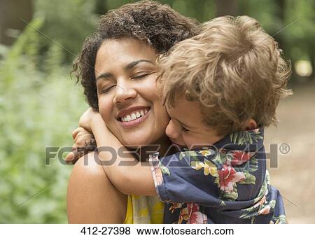 Close up affectionate mother and son hugging with eyes closed View Large Photo Image Stock Photo - Close up affectionate mother and son hugging with eyes closed. Fotosearch