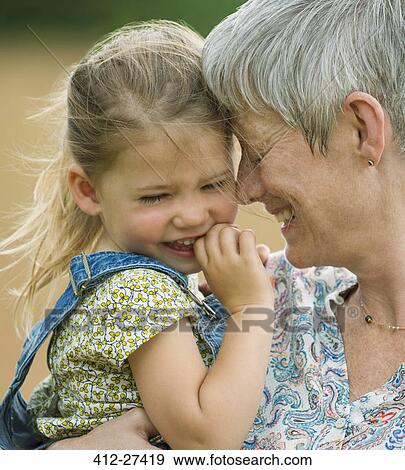 Close up grandmother and granddaughter hugging View Large Photo Image Stock Photo - Close up grandmother and granddaughter hugging. Fotosearch