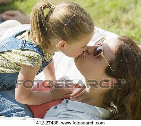 Stock Photo - Close up mother and daughter kissing. Fotosearch