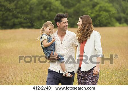 Family walking in rural field View Large Photo Image Stock Image - Family walking in rural field. Fotosearch