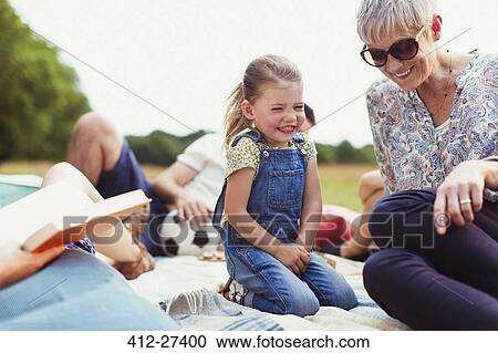 Grandmother and granddaughter laughing on blanket View Large Photo Image Stock Image - Grandmother and granddaughter laughing on blanket. Fotosearch