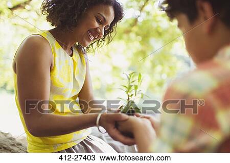 Mother and son cupping seedling outdoors View Large Photo Image Stock Image - Mother and son cupping seedling outdoors. Fotosearch