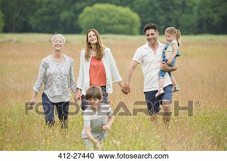 Multi-generation family holding hands and walking in rural field View Large Photo Image Stock Image - Multi-generation family holding hands and walking in rural field. Fotosearch