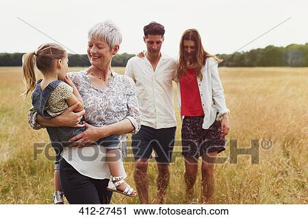 Multi-generation family walking in rural field View Large Photo Image Stock Image - Multi-generation family walking in rural field. Fotosearch