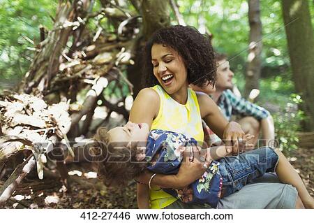 Playful mother and son in woods View Large Photo Image Stock Photograph - Playful mother and son in woods. Fotosearch