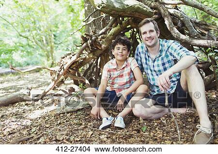 Portrait smiling father and son in woods View Large Photo Image Picture - Portrait smiling father and son in woods. Fotosearch
