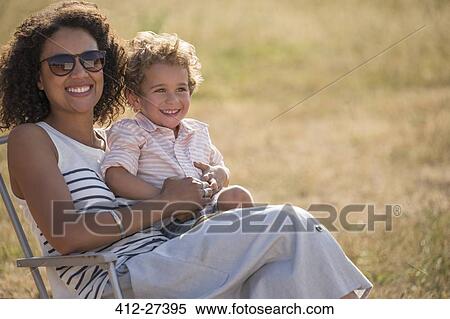 Portrait smiling mother and son in sunny field View Large Photo Image Stock Photography - Portrait smiling mother and son in sunny field. Fotosearch