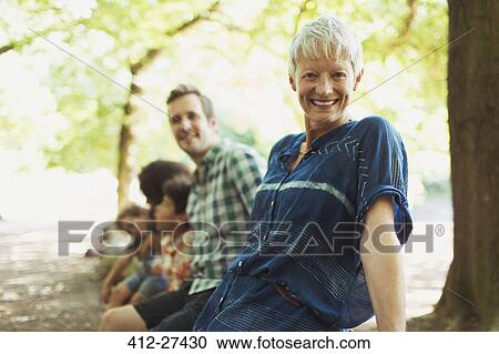 Portrait smiling multi-generation family in woods View Large Photo Image Stock Image - Portrait smiling multi-generation family in woods. Fotosearch