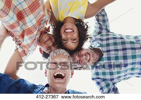 Stock Photo - Portrait smiling multi-generation family in huddle. Fotosearch