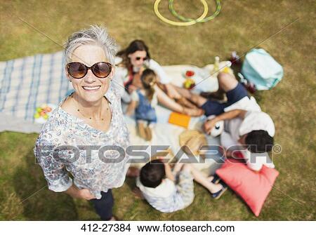 Portrait smiling senior woman with family at picnic View Large Photo Image Picture - Portrait smiling senior woman with family at picnic. Fotosearch