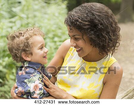 Smiling mother and son face to face View Large Photo Image Stock Image - Smiling mother and son face to face. Fotosearch