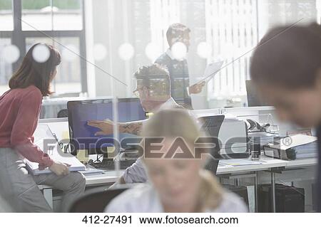 Stock Image - Business people working at computer in office. Fotosearch