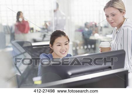 Businesswomen working at computer in office View Large Photo Image Stock Photo - Businesswomen working at computer in office. Fotosearch