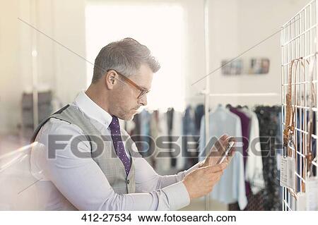 Fashion designer photographing swatches with camera phone View Large Photo Image Picture - Fashion designer photographing swatches with camera phone. Fotosearch