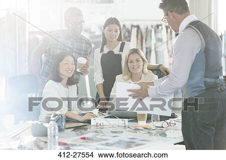 Fashion designers brainstorming with proofs and swatches in office View Large Photo Image Picture - Fashion designers brainstorming with proofs and swatches in office. Fotosearch
