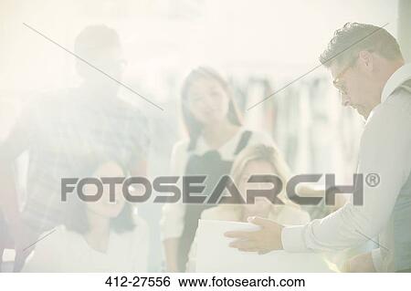 Stock Photograph - Fashion designers meeting in sunny office. Fotosearch