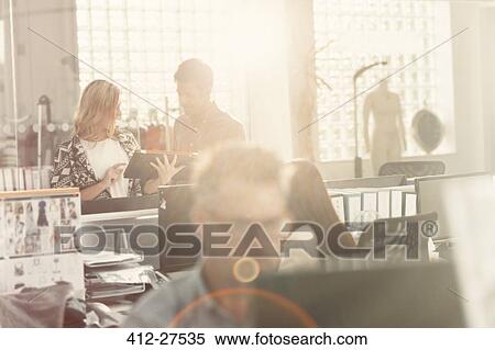 Stock Photography - Fashion designers meeting in sunny office. Fotosearch
