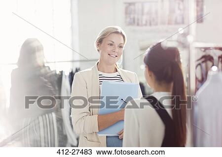 Fashion designers talking in office View Large Photo Image Stock Image - Fashion designers talking in office. Fotosearch