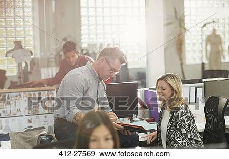 Fashion designers using digital tablet in office View Large Photo Image Stock Photo - Fashion designers using digital tablet in office. Fotosearch