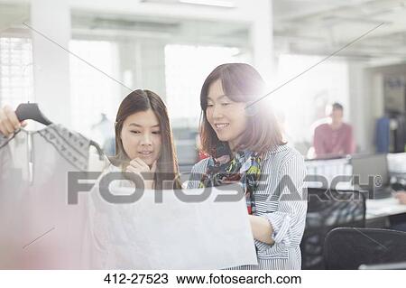 Fashion designers with clothing and sewing pattern in office View Large Photo Image Stock Image - Fashion designers with clothing and sewing pattern in office. Fotosearch
