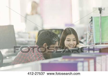 Fashion designers working at computer in office View Large Photo Image Stock Photo - Fashion designers working at computer in office. Fotosearch