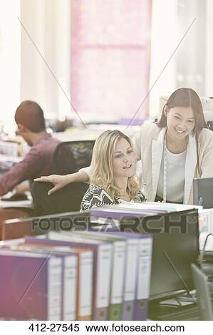 Fashion designers working at desk in office View Large Photo Image Stock Photography - Fashion designers working at desk in office. Fotosearch