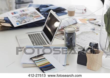 Laptop, swatches, proofs and paperwork on desk in fashion desk office View Large Photo Image Stock Image - Laptop, swatches, proofs and paperwork on desk in fashion desk office. Fotosearch