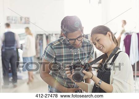 Photographer and fashion designer looking at camera in office View Large Photo Image Stock Photo - Photographer and fashion designer looking at camera in office. Fotosearch