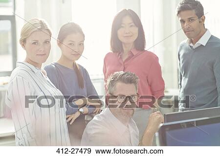 Portrait confident business people in sunny office View Large Photo Image Stock Photo - Portrait confident business people in sunny office. Fotosearch