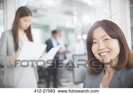 Stock Image - Portrait confident businesswoman in office. Fotosearch
