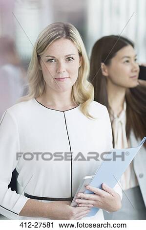 Portrait confident businesswoman with folder and digital tablet View Large Photo Image Stock Image - Portrait confident businesswoman with folder and digital tablet. Fotosearch