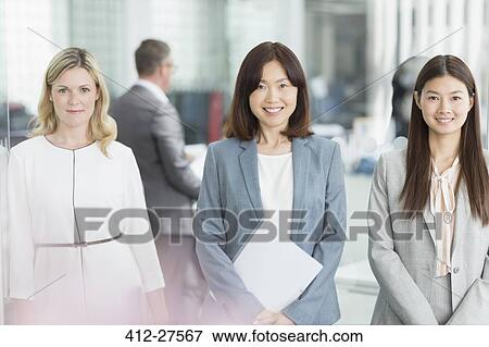 Portrait confident businesswomen in office View Large Photo Image Stock Photo - Portrait confident businesswomen in office. Fotosearch