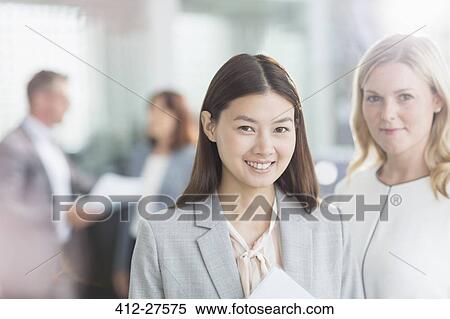 Portrait confident businesswomen in office View Large Photo Image Stock Photography - Portrait confident businesswomen in office. Fotosearch