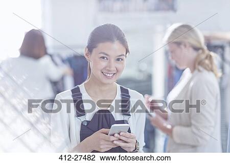 Portrait confident fashion designer texting with cell phone View Large Photo Image Stock Image - Portrait confident fashion designer texting with cell phone. Fotosearch