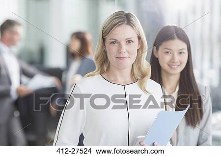 Picture - Portrait smiling businesswomen in office. Fotosearch