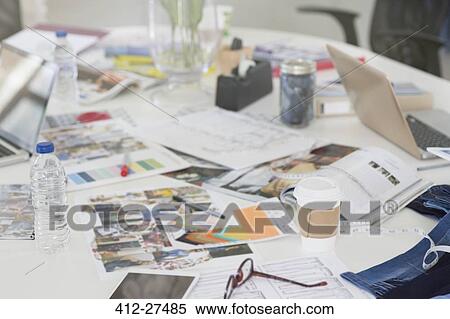 Stock Photography - Proofs, swatches and paperwork on conference table. Fotosearch