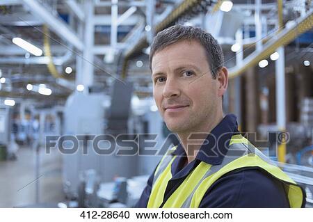 Stock Image - Close up portrait confident worker in factory. Fotosearch
