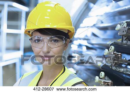 Close up portrait female confident worker in hard-hat and protective eyewear View Large Photo Image Stock Photo - Close up portrait female confident worker in hard-hat and protective eyewear. Fotosearch