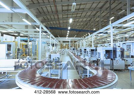 Conveyor belt and machinery in empty factory View Large Photo Image Stock Photo - Conveyor belt and machinery in empty factory. Fotosearch