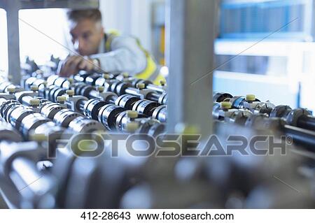 Engineer examining printing press conveyor belt View Large Photo Image Stock Image - Engineer examining printing press conveyor belt. Fotosearch
