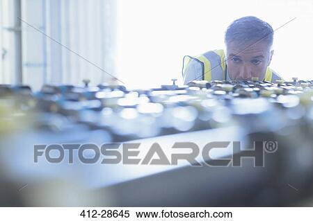 Engineer examining printing press conveyor belt View Large Photo Image Stock Photography - Engineer examining printing press conveyor belt. Fotosearch