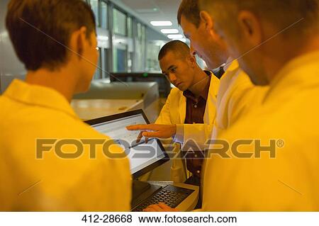 Engineers around computer in factory View Large Photo Image Stock Photo - Engineers around computer in factory. Fotosearch