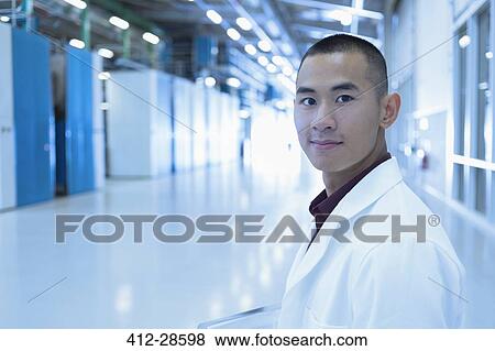 Portrait confident scientist in factory corridor View Large Photo Image Stock Photo - Portrait confident scientist in factory corridor. Fotosearch