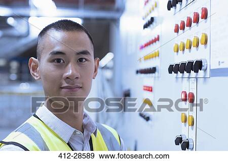 Portrait confident worker at control panel in factory View Large Photo Image Stock Photo - Portrait confident worker at control panel in factory. Fotosearch