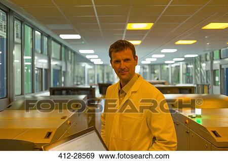 Portrait smiling worker among printers in printing plant View Large Photo Image Stock Photo - Portrait smiling worker among printers in printing plant. Fotosearch