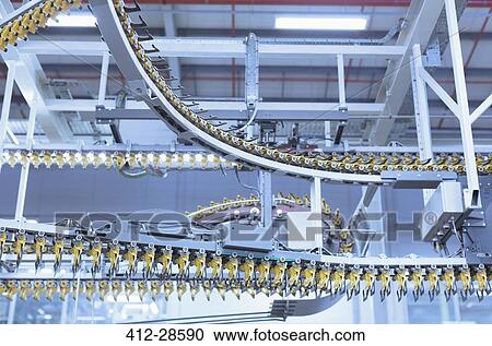 Stock Image - Printing press conveyor belts overhead. Fotosearch